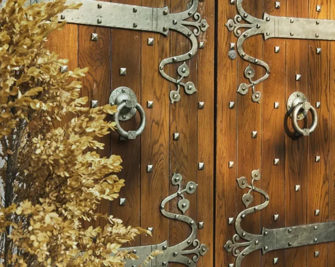 ornate wooden ranch gate with metal straps and hinges