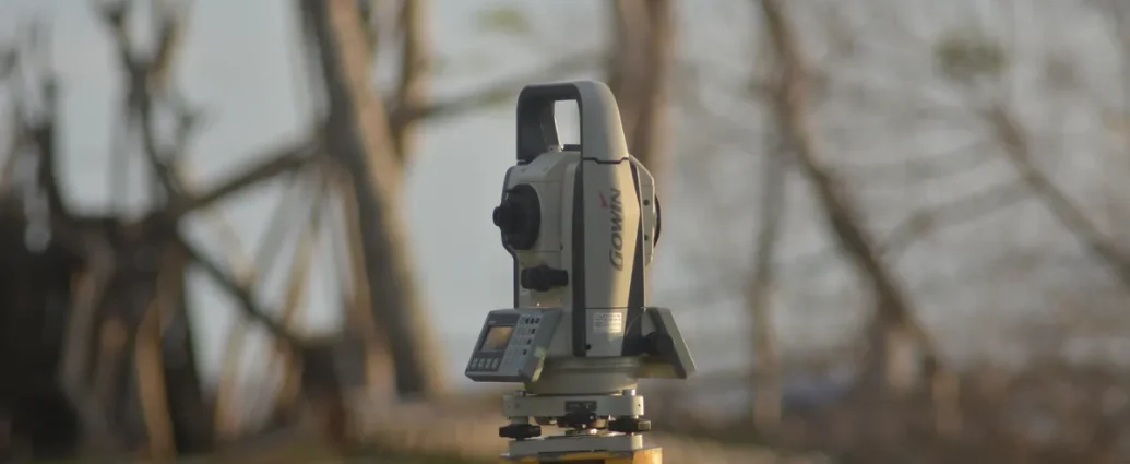 surveying instrument on tripod outdoors
